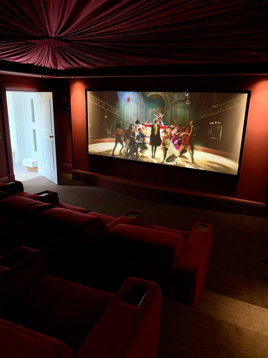 Angle of Home Cinema room showing projector screen, lighting, and cinema chairs
