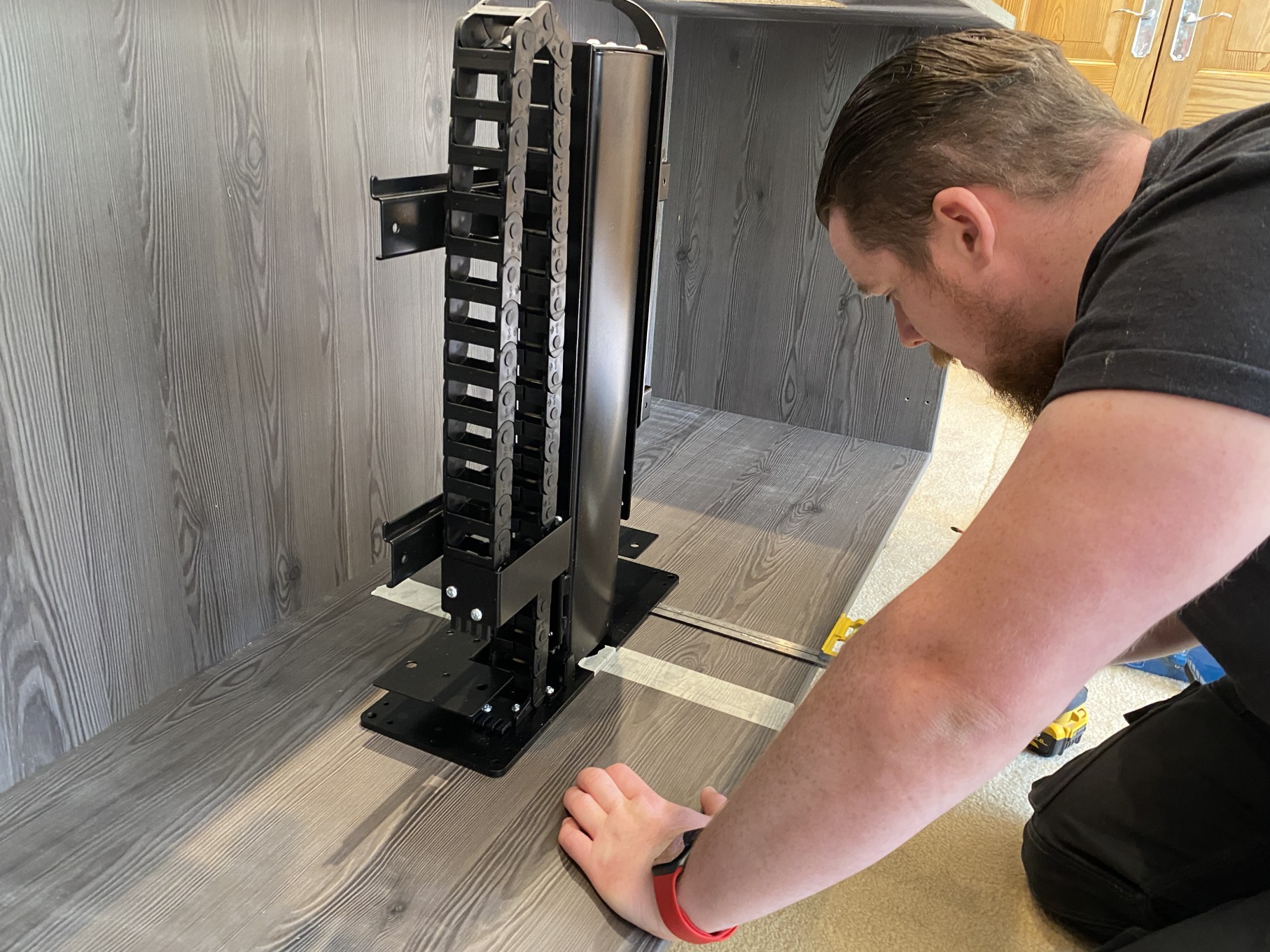 Technician working on motorised TV stand