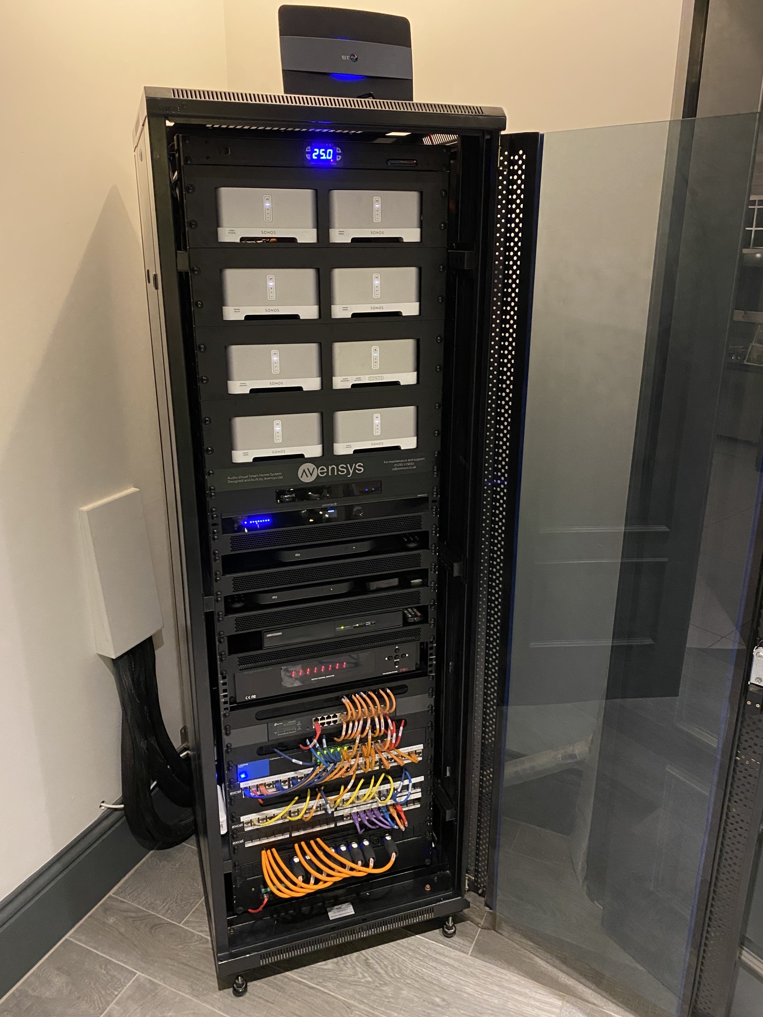 Multimedia AV rack with multiple Sonos Connects, Sky Q boxes, and network switches cable managed and optimised