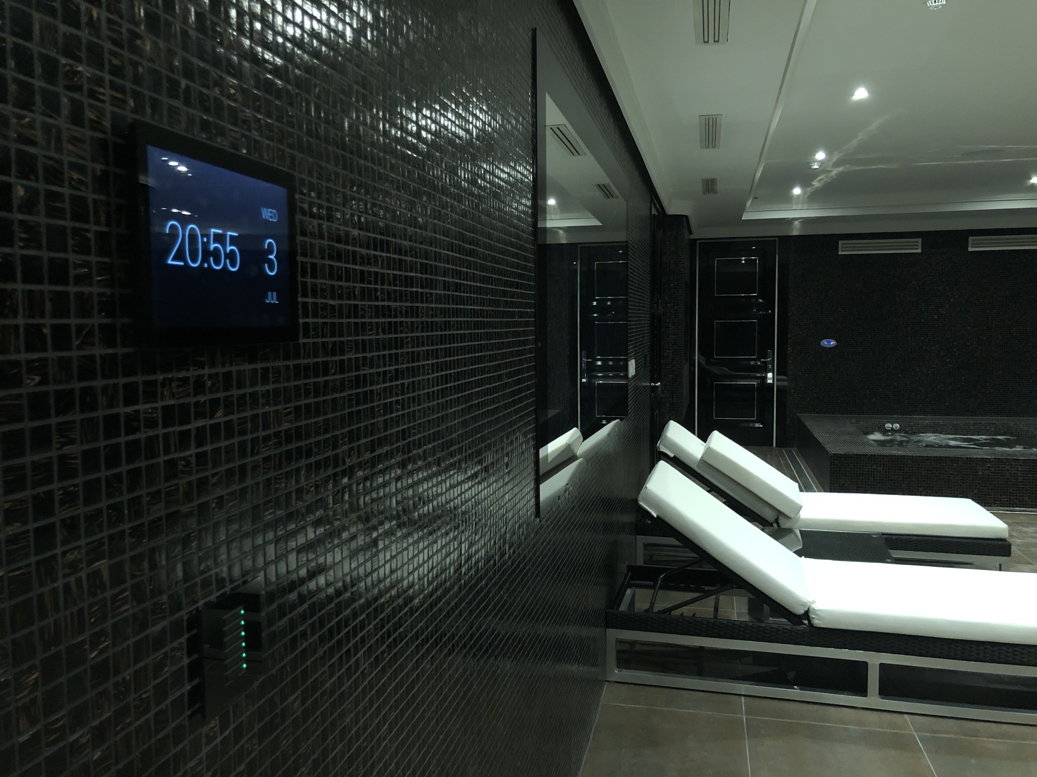 Spa area with built-in Control4 panels and ceiling lighting