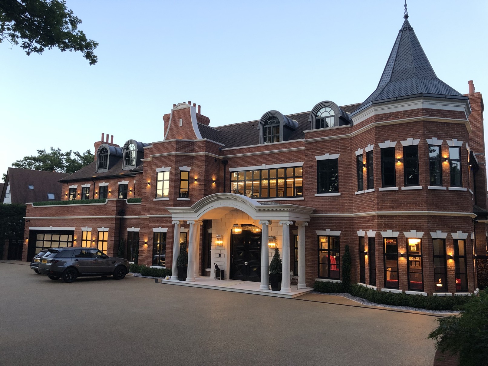 Front of mansion house showcasing built-in lighting