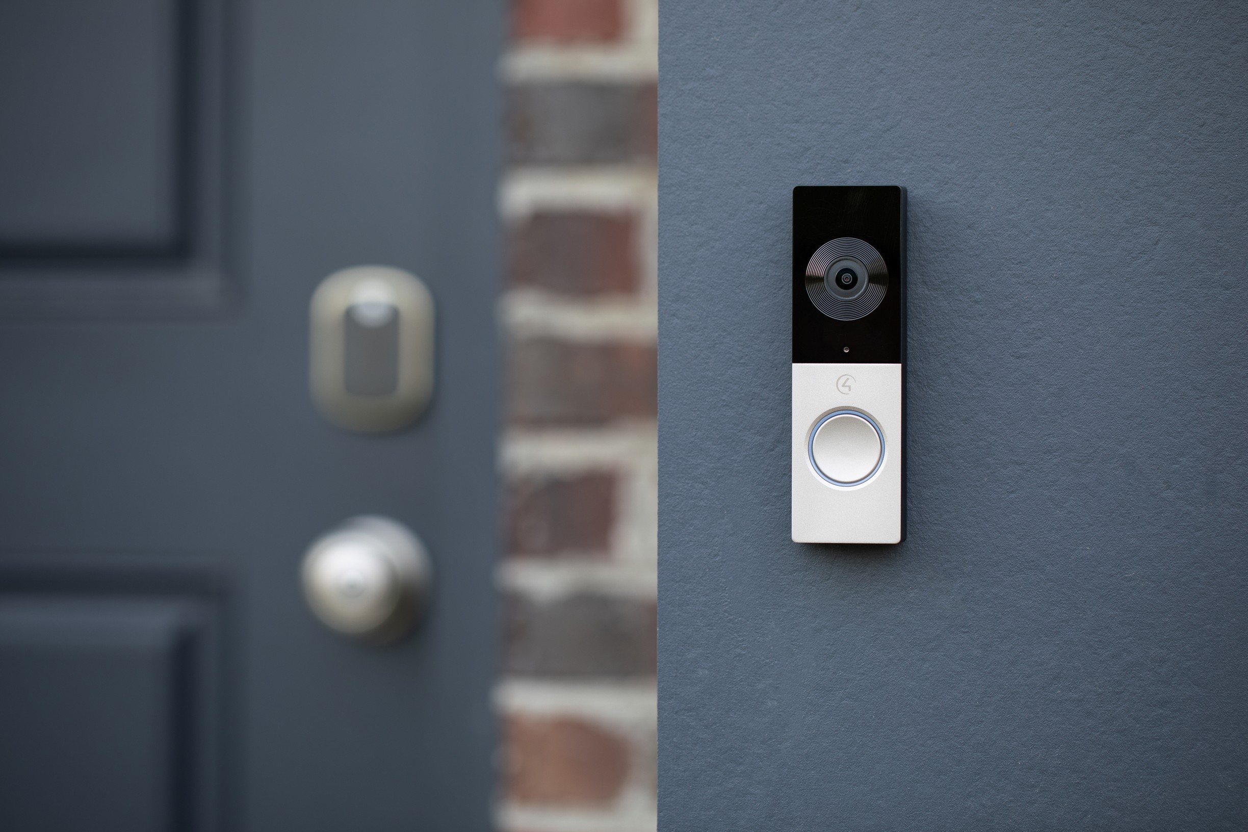 Control4 door bell attached to wall near front door